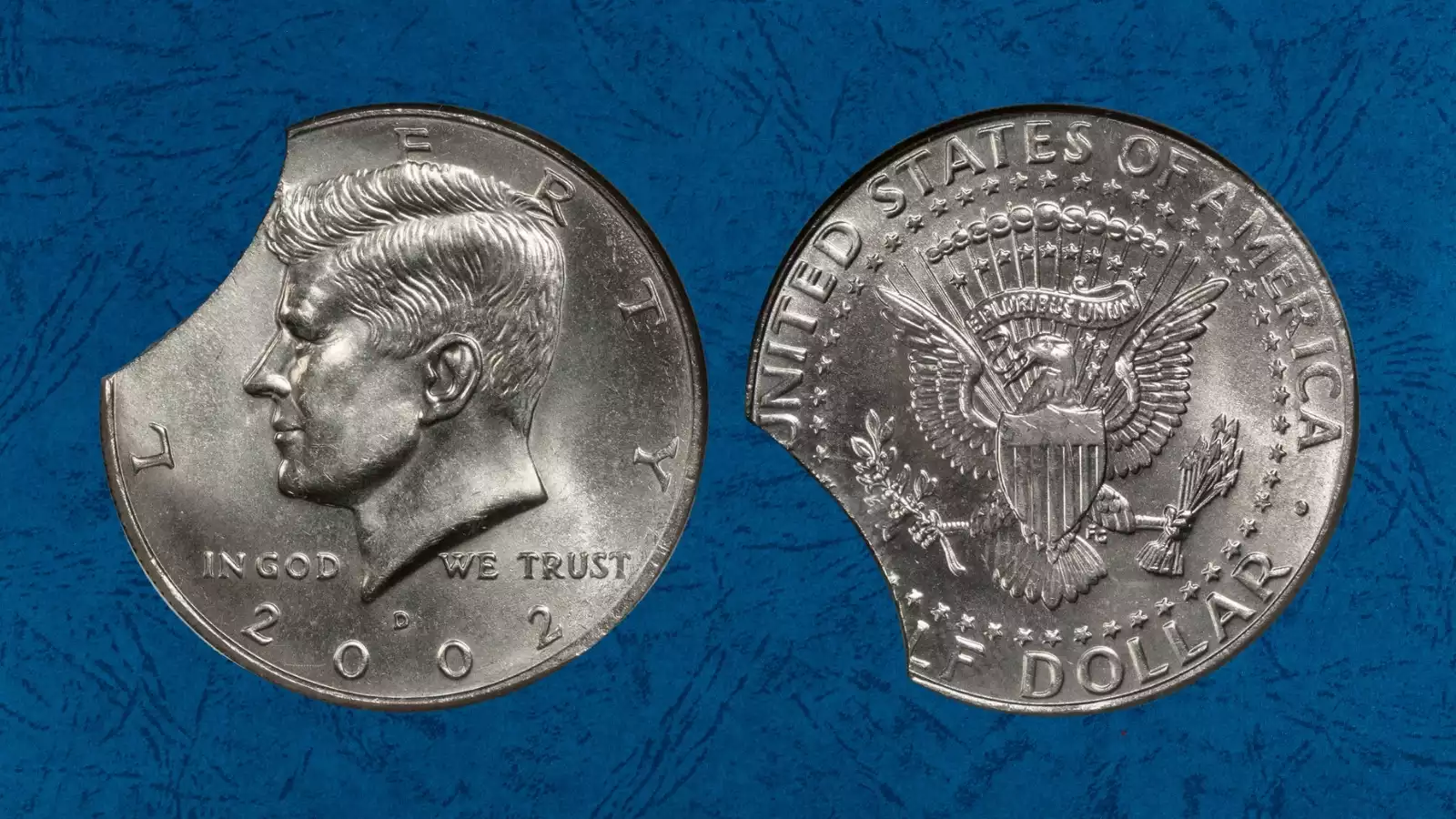 2002-D Kennedy half dollar clipped planchet error showing curved missing metal segment on coin edge